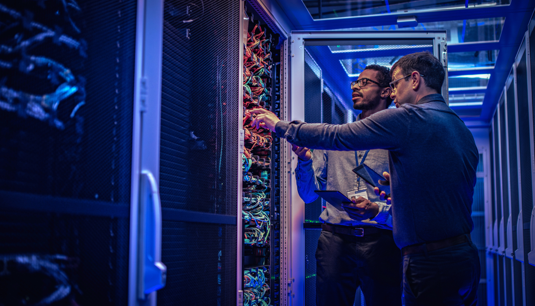 two man looking at a server rack